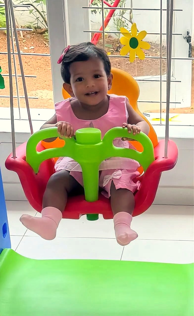 A little one enjoying the swing at Little Blessings